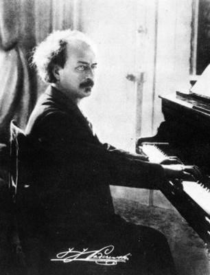 Ignacy Jan Paderewski siedzi przy fortepianie. Zdjęcie czarno białe.